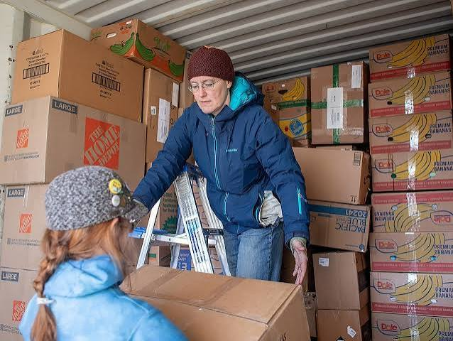 person loading boxes onto truck